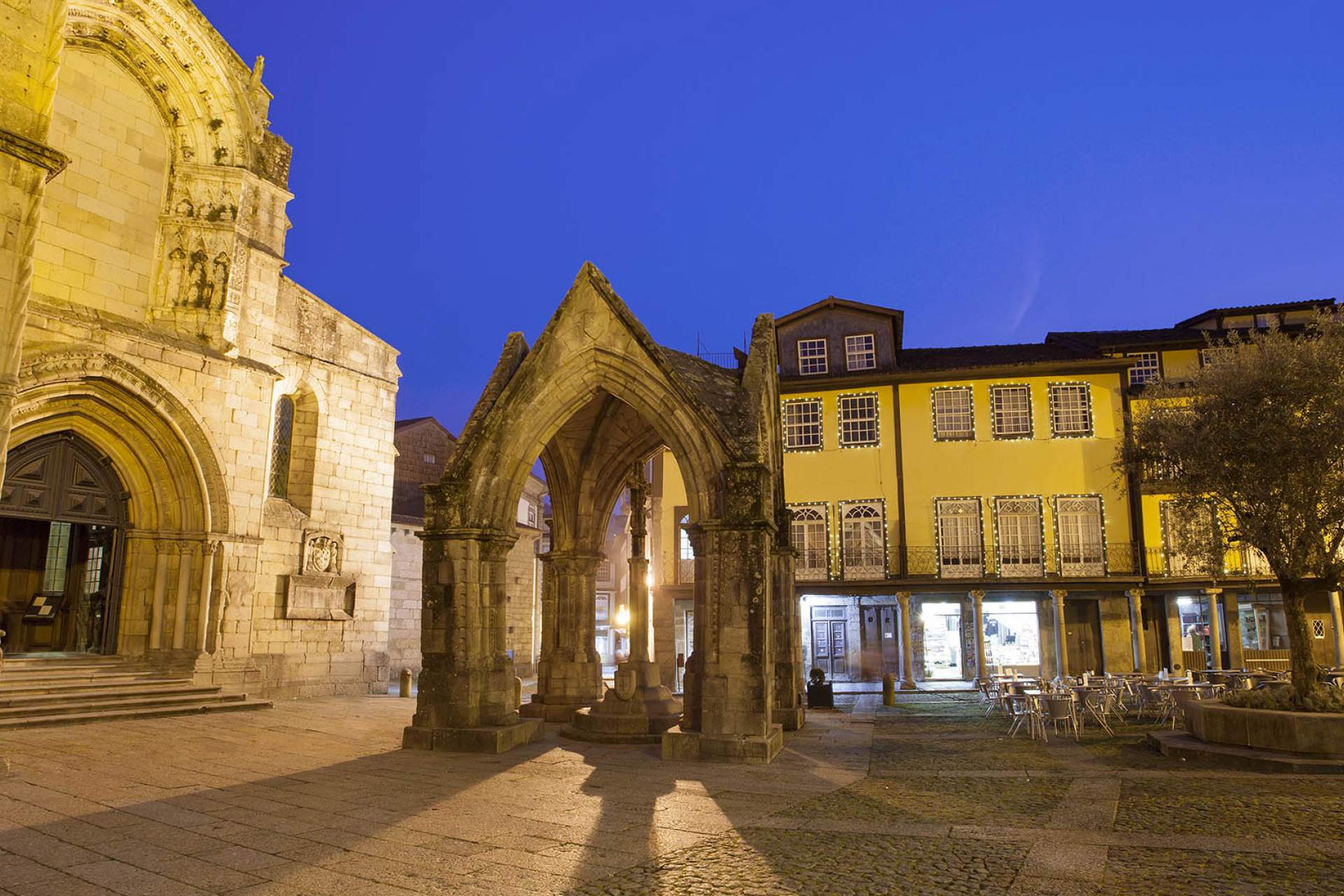 Largo da Oliveira em Guimarães, com a fachada da Igreja de Nossa Senhora da Oliveira e o padrão comemorativo da Batalha do Salado em Guimarães / Guimarães / cristovao_Shutterstock